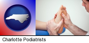 a podiatrist practicing reflexology on a human foot in Charlotte, NC