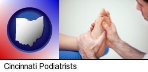 a podiatrist practicing reflexology on a human foot in Cincinnati, OH