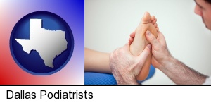 Dallas, Texas - a podiatrist practicing reflexology on a human foot