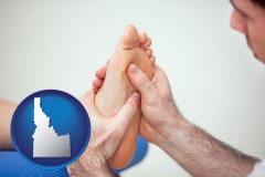 idaho map icon and a podiatrist practicing reflexology on a human foot