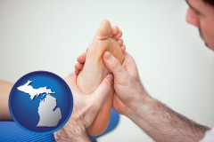 michigan map icon and a podiatrist practicing reflexology on a human foot