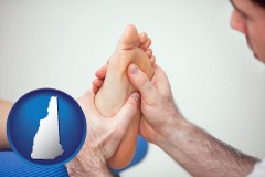 new-hampshire map icon and a podiatrist practicing reflexology on a human foot
