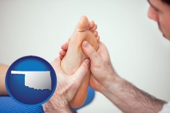 oklahoma map icon and a podiatrist practicing reflexology on a human foot