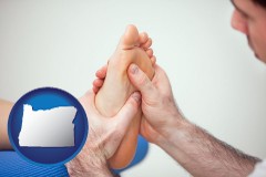 oregon map icon and a podiatrist practicing reflexology on a human foot