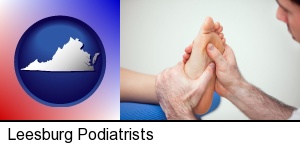 a podiatrist practicing reflexology on a human foot in Leesburg, VA